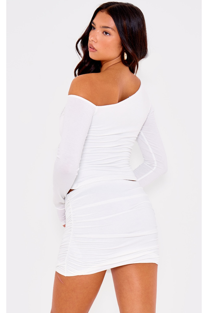 Асиметричний топ з довгими рукавами з кремового контуру