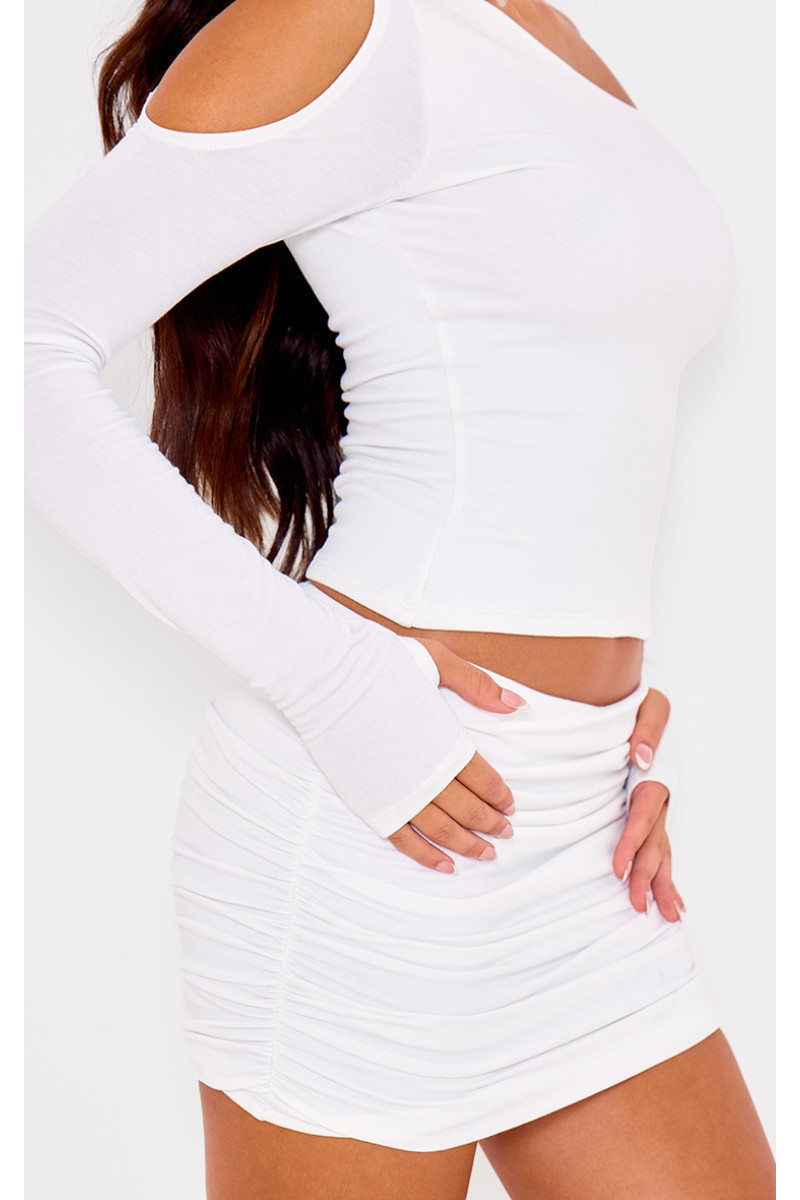 Асиметричний топ з довгими рукавами з кремового контуру