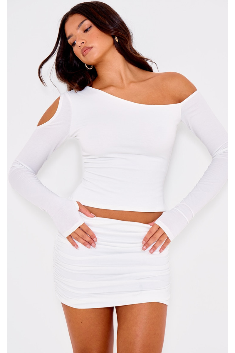 Асиметричний топ з довгими рукавами з кремового контуру